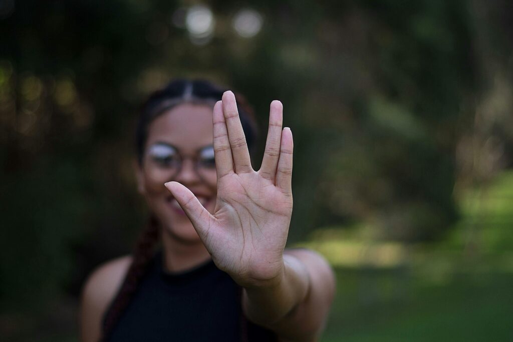 A Woman Flashing the Vulcan Salute Hand Sign